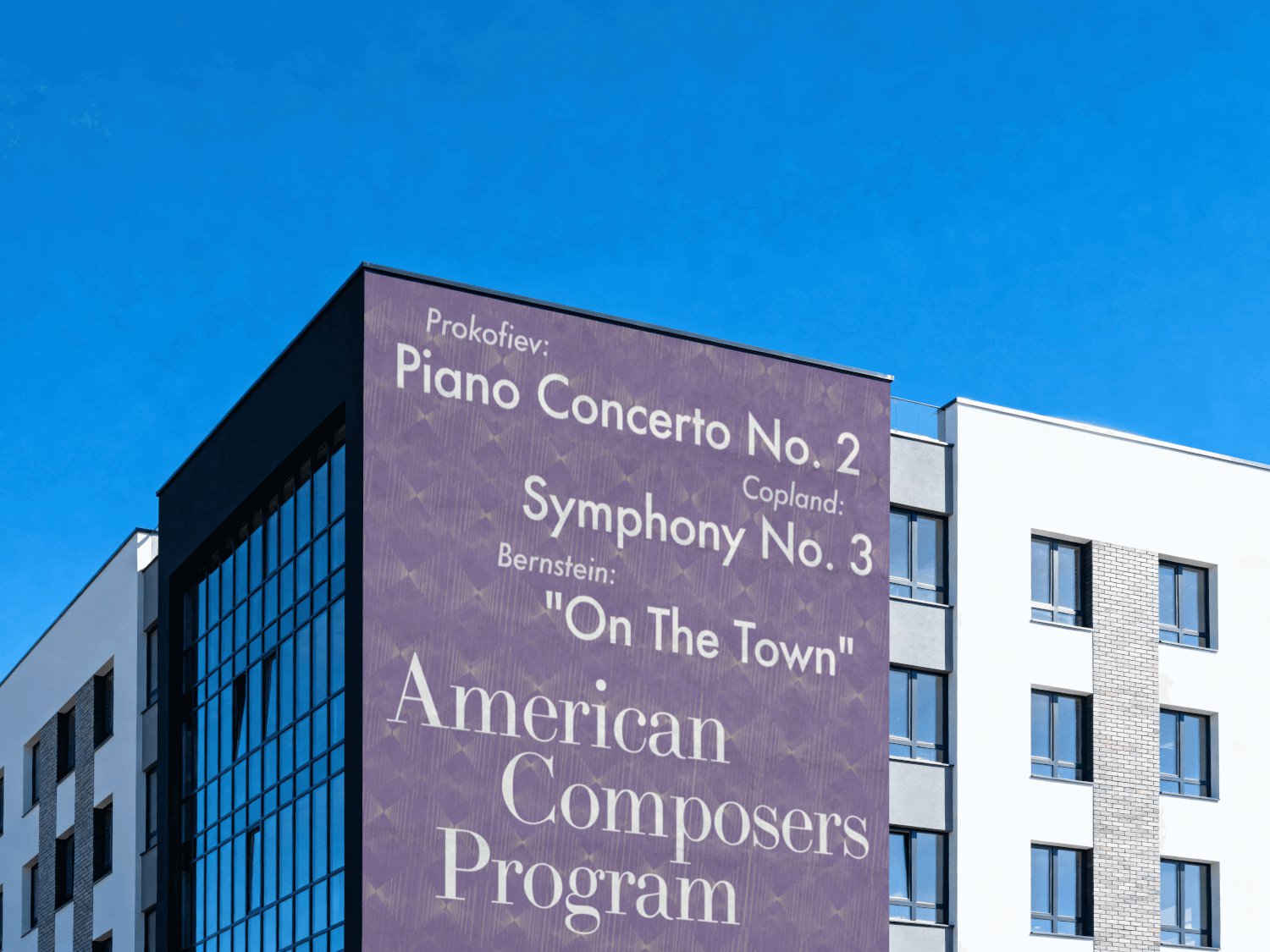 The American Composers Program poster printed across a building wall